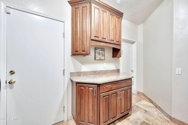 15413 S 31st Pl, Phoenix, AZ 85048 - kitchen with light countertops, stone finish floor, baseboards, and brown cabinets