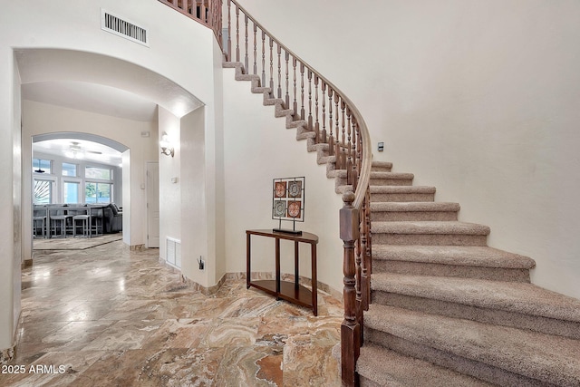 15413 S 31st Pl, Phoenix, AZ 85048 - staircase with arched walkways, a towering ceiling, and visible vents