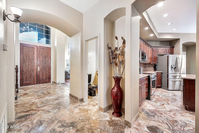 15413 S 31st Pl, Phoenix, AZ 85048 - entryway with arched walkways, stone finish flooring, baseboards, and recessed lighting