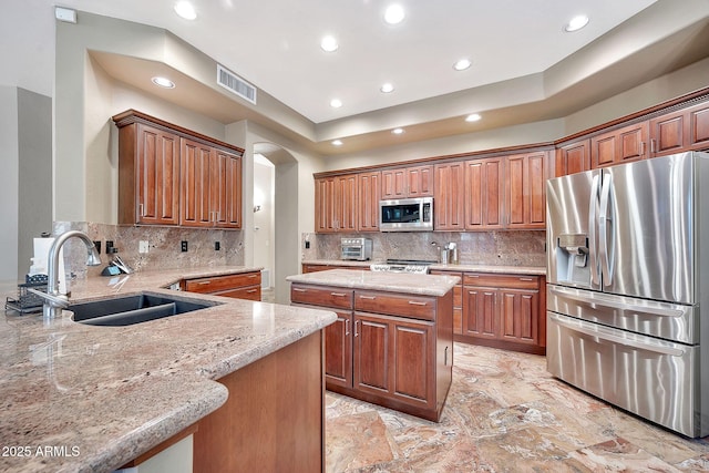 15413 S 31st Pl, Phoenix, AZ 85048 - kitchen featuring stainless steel appliances, a sink, arched walkways, visible vents, and light stone countertops