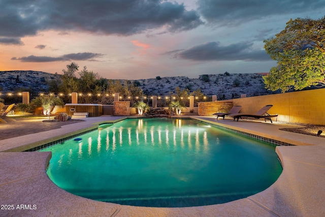 15413 S 31st Pl, Phoenix, AZ 85048 - pool at dusk featuring a fenced in pool, a mountain view, fence, and a patio area