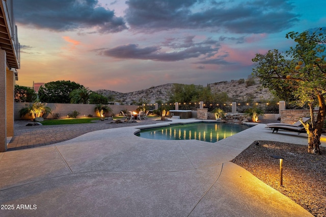 15413 S 31st Pl, Phoenix, AZ 85048 - pool at dusk featuring a fenced backyard, a patio, a mountain view, and a fenced in pool