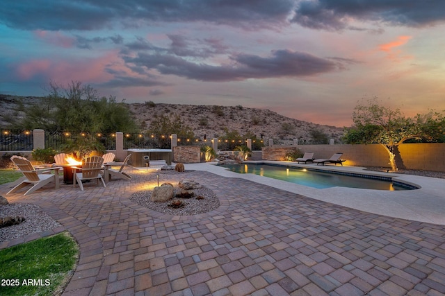 15413 S 31st Pl, Phoenix, AZ 85048 - pool at dusk featuring fence, a mountain view, a patio, a fenced in pool, and a fire pit
