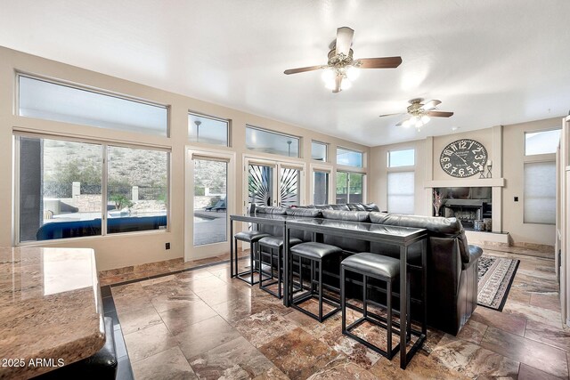 15413 S 31st Pl, Phoenix, AZ 85048 - living area featuring a tile fireplace and a ceiling fan