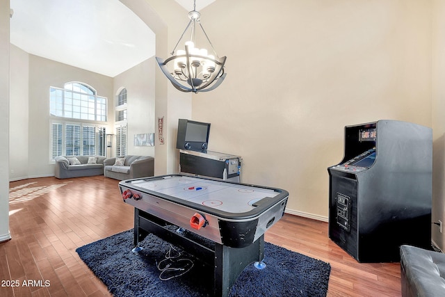 15413 S 31st Pl, Phoenix, AZ 85048 - recreation room with baseboards, a chandelier, and wood finished floors