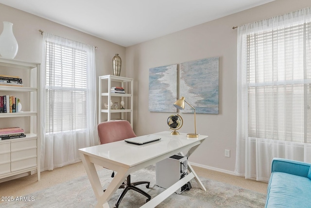 office space with light carpet and baseboards