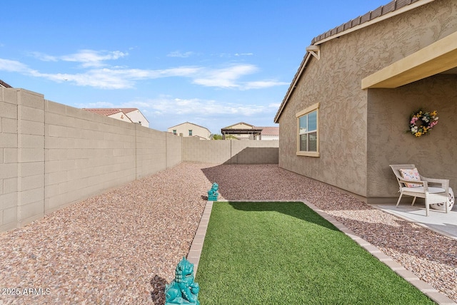 view of yard with a patio area and a fenced backyard