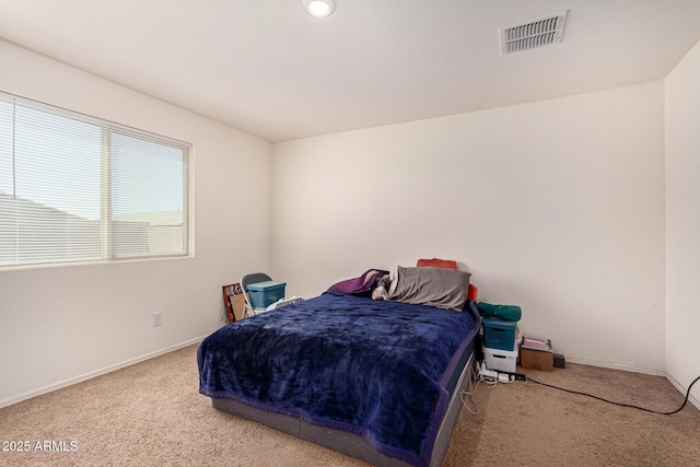 bedroom featuring baseboards, visible vents, and carpet