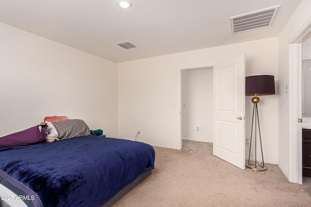 bedroom featuring baseboards, visible vents, and light carpet