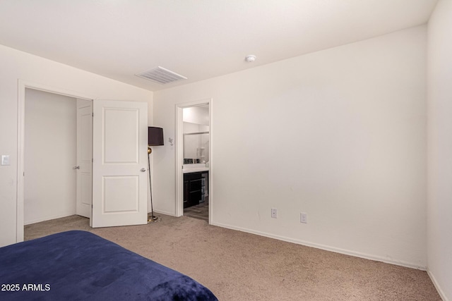 unfurnished bedroom featuring baseboards, visible vents, ensuite bathroom, and light colored carpet