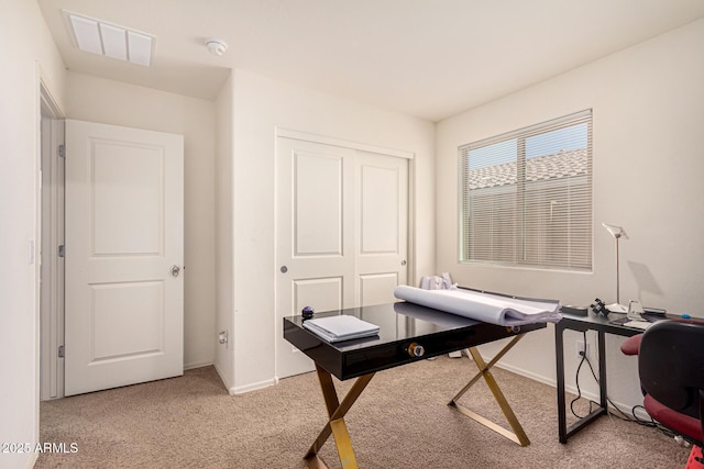 home office featuring visible vents, baseboards, and light carpet