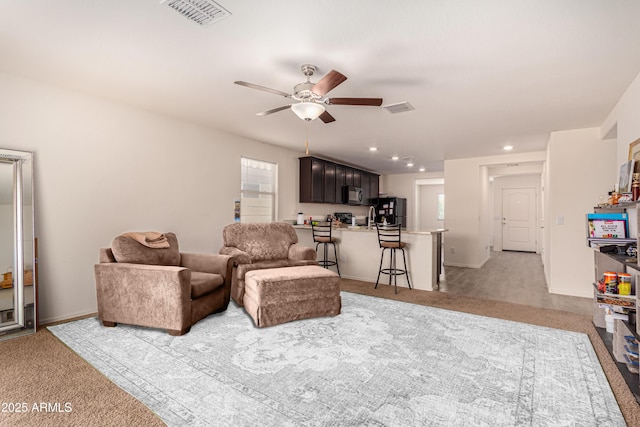 carpeted living area with recessed lighting, visible vents, ceiling fan, and baseboards