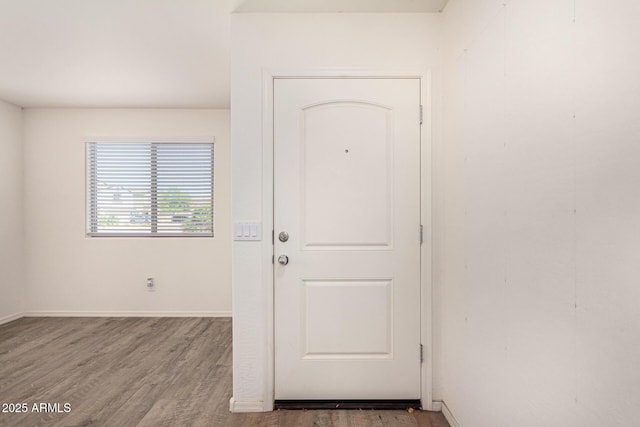 spare room featuring wood finished floors and baseboards