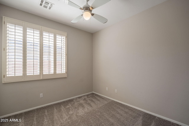 unfurnished room featuring baseboards, carpet, a ceiling fan, and visible vents