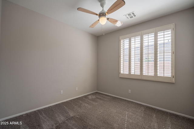 empty room with baseboards, ceiling fan, carpet flooring, and visible vents