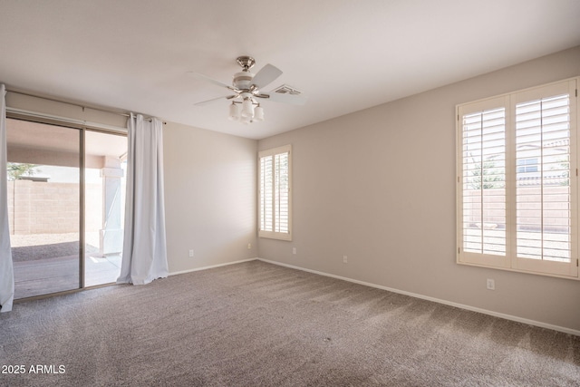 unfurnished room with baseboards, a ceiling fan, carpet flooring, and visible vents