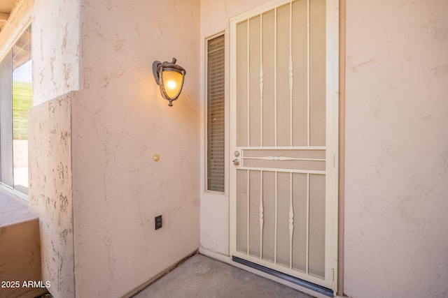 view of exterior entry with stucco siding
