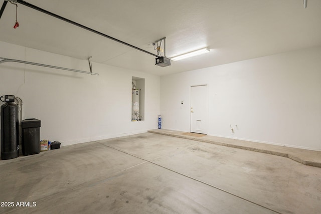 garage featuring baseboards, a garage door opener, and gas water heater