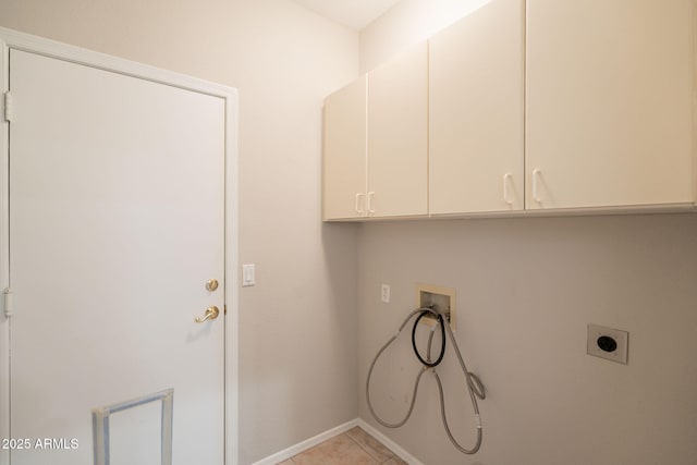laundry area featuring washer hookup, electric dryer hookup, cabinet space, baseboards, and light tile patterned flooring