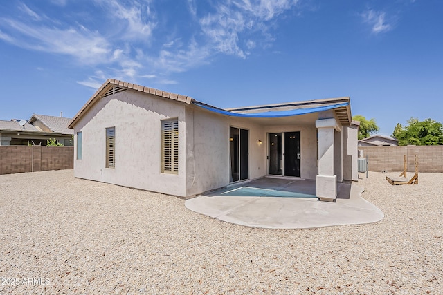 back of house featuring central air condition unit, a fenced backyard, a patio area, and stucco siding