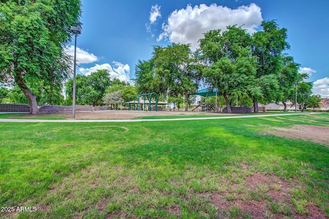 view of home's community with a lawn and playground community