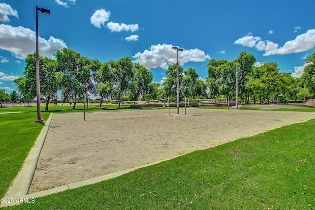 surrounding community featuring volleyball court and a lawn