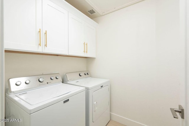 laundry room featuring independent washer and dryer and cabinets