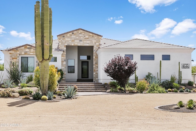 6133 E Dixileta Dr, Cave Creek, AZ 85331 - modern home with stone siding, stucco siding, and a tile roof