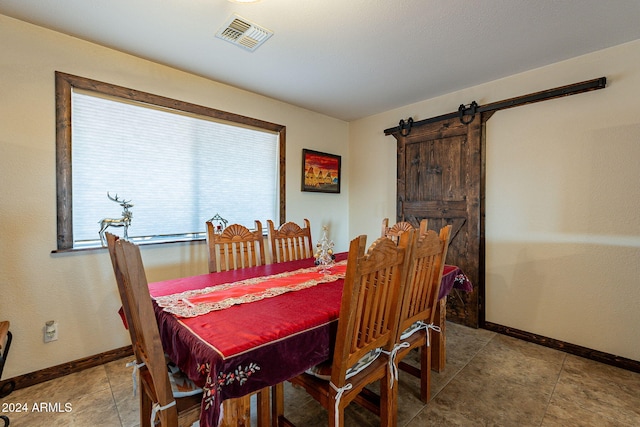 dining space featuring a barn door