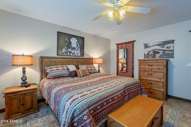 bedroom featuring light tile patterned floors and ceiling fan