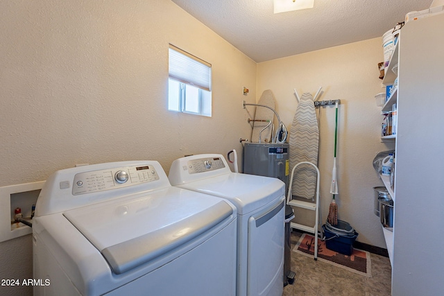 washroom with washer and dryer and a textured ceiling