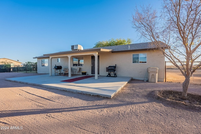 rear view of property featuring a patio area and central AC