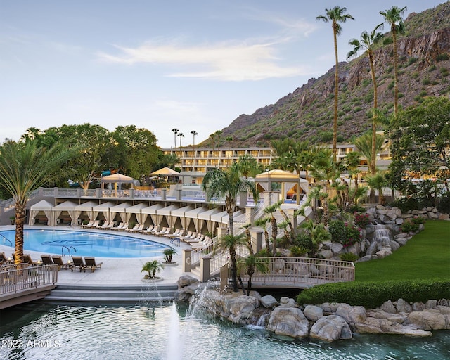 view of pool with a water and mountain view