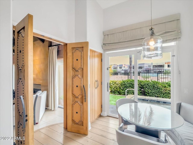 dining space featuring a water view and light wood-type flooring