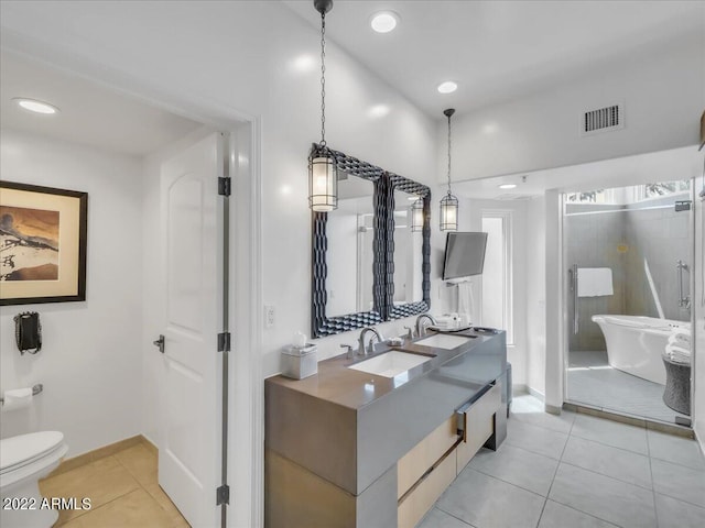 bathroom with vanity, tile patterned floors, toilet, and a bathing tub