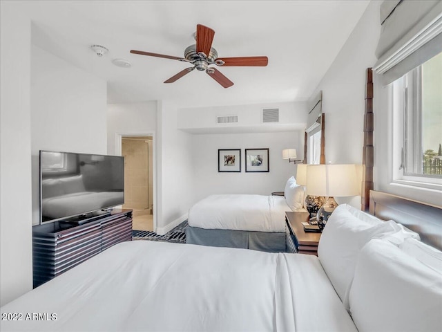 bedroom with multiple windows and ceiling fan