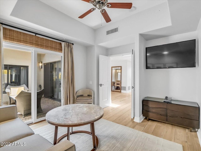 living room featuring ceiling fan and light hardwood / wood-style floors