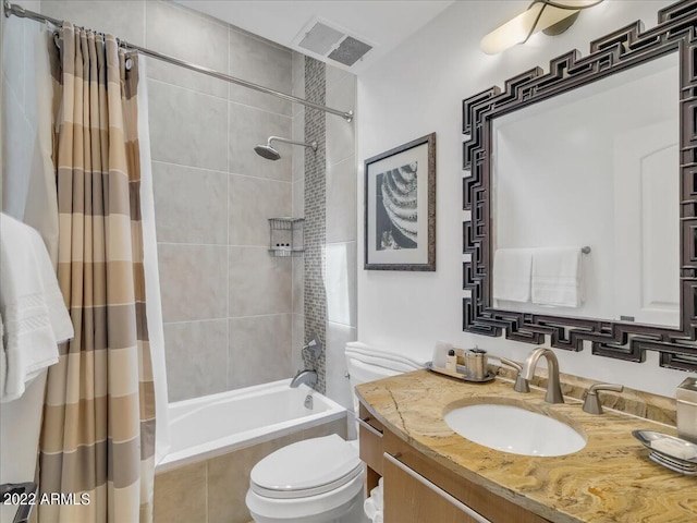 full bathroom featuring vanity, shower / bathtub combination with curtain, and toilet