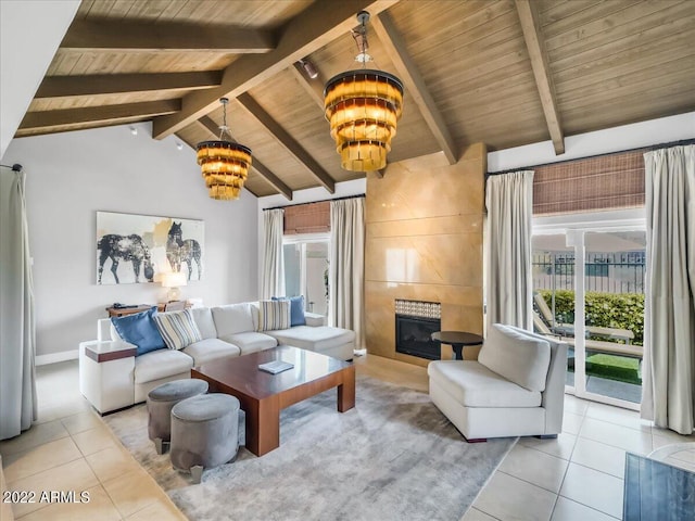 living room featuring a fireplace, vaulted ceiling with beams, light tile patterned floors, a notable chandelier, and wood ceiling