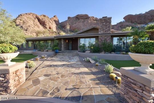 view of front of house with a patio and a mountain view