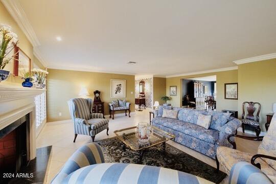 living room featuring crown molding and light tile patterned flooring