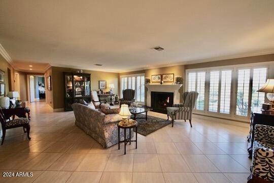 living room with crown molding, plenty of natural light, and light tile patterned floors