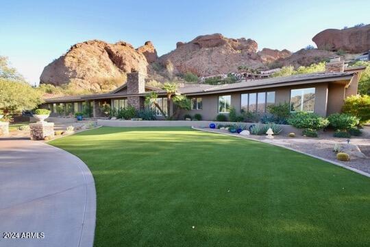 exterior space featuring a front yard and a mountain view