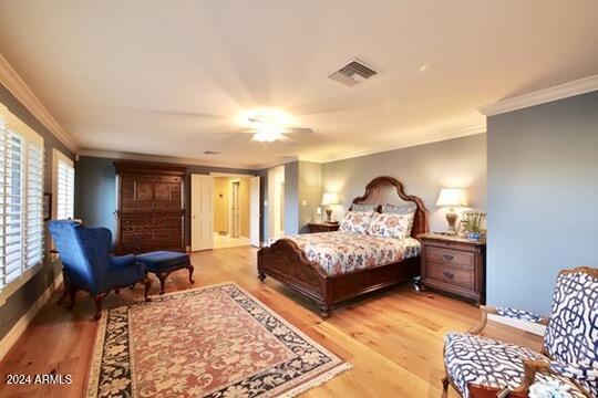 bedroom with ornamental molding, light hardwood / wood-style floors, and ceiling fan