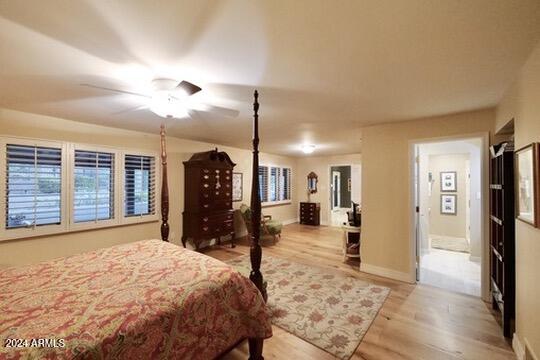 bedroom with light wood-type flooring and ceiling fan