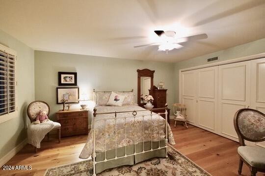 bedroom featuring a closet, ceiling fan, and light hardwood / wood-style flooring