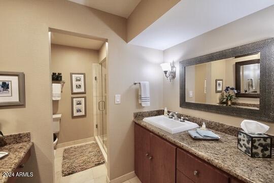 bathroom featuring vanity, walk in shower, and tile patterned floors