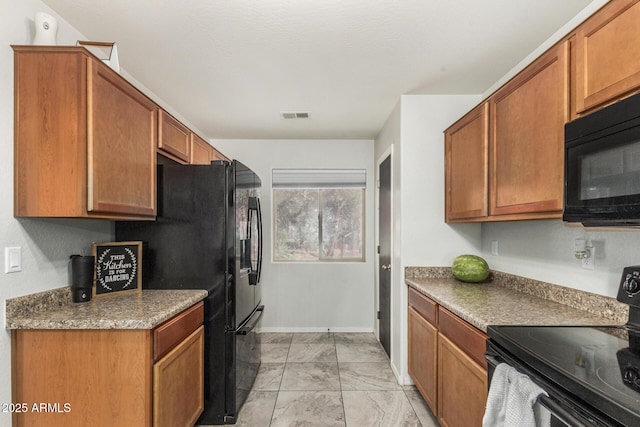 1940 W Expressman St, Apache Junction, AZ 85120 - kitchen with black appliances, light marble finish flooring, and brown cabinets