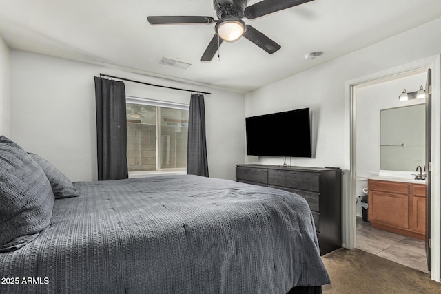 1940 W Expressman St, Apache Junction, AZ 85120 - carpeted bedroom with connected bathroom and a ceiling fan