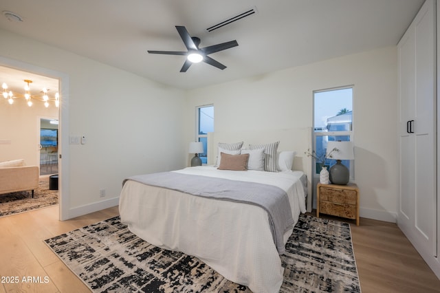 8215 E Virginia Ave, Scottsdale, AZ 85257 - bedroom featuring light wood finished floors, baseboards, and a ceiling fan